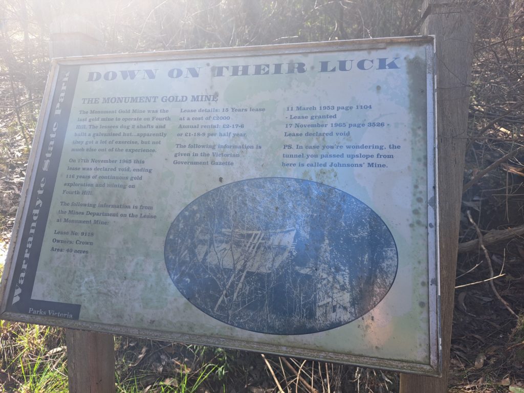 An informative sign about the mine shaft.